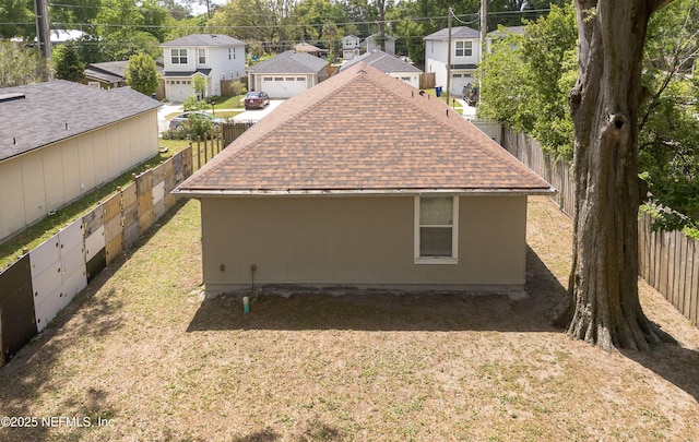 8413 Free Ave, Jacksonville, FL 32211 - exterior space with a fenced backyard, a residential view, a lawn, and roof with shingles