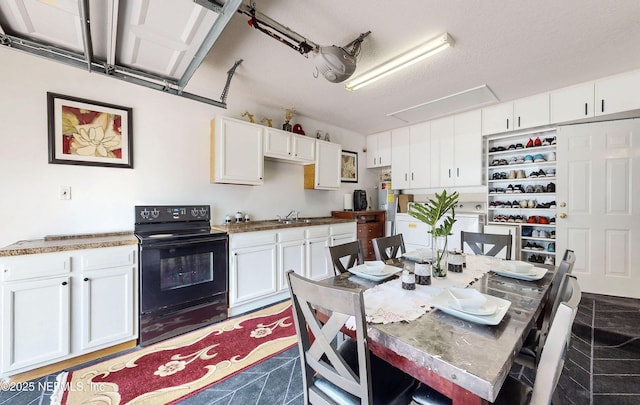 8413 Free Ave, Jacksonville, FL 32211 - kitchen with black electric range, white cabinets, and a sink