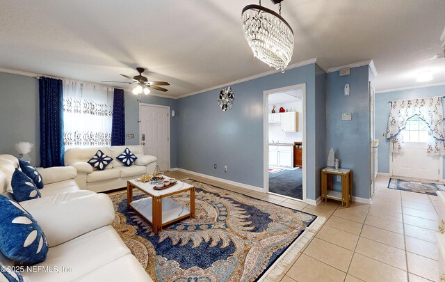 8413 Free Ave, Jacksonville, FL 32211 - living room with ceiling fan with notable chandelier, light tile patterned floors, baseboards, and ornamental molding