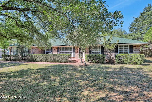 ranch-style home with brick siding and a front yard