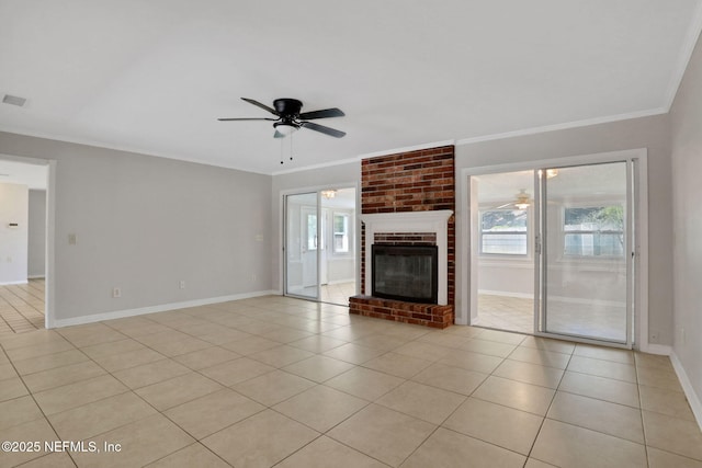 unfurnished living room with light tile patterned flooring, crown molding, a wealth of natural light, and a ceiling fan