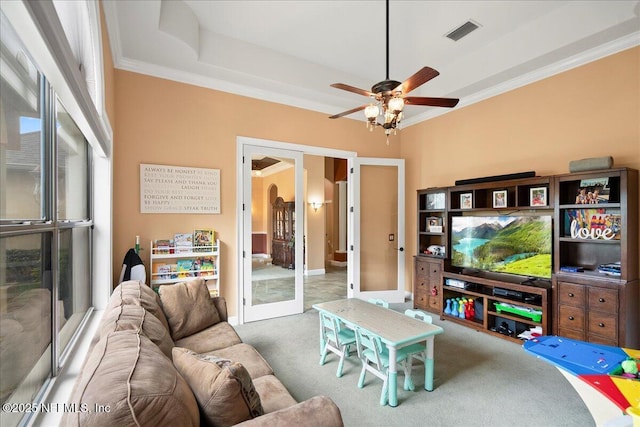 15 Dartmouth Trce, Ormond Beach, FL 32174 - carpeted living area featuring a raised ceiling, a ceiling fan, visible vents, ornamental molding, and french doors