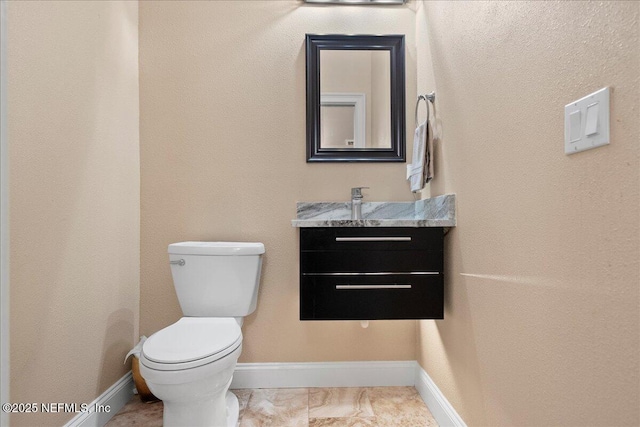 15 Dartmouth Trce, Ormond Beach, FL 32174 - bathroom featuring toilet, vanity, and baseboards