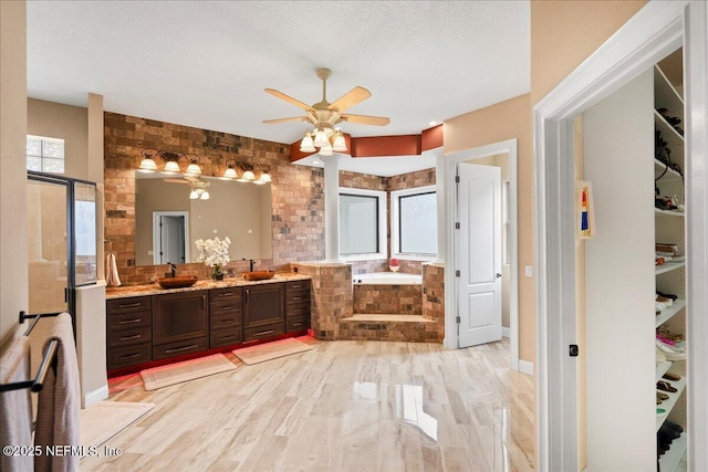 15 Dartmouth Trce, Ormond Beach, FL 32174 - bathroom with a sink, a bath, a ceiling fan, double vanity, and wood finished floors