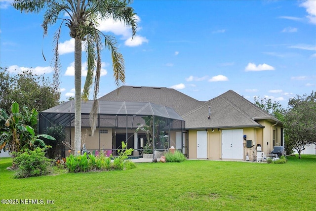 15 Dartmouth Trce, Ormond Beach, FL 32174 - rear view of house with a lanai, stucco siding, and a yard