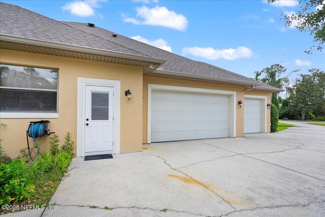 15 Dartmouth Trce, Ormond Beach, FL 32174 - exterior space with an attached garage, driveway, stucco siding, and roof with shingles