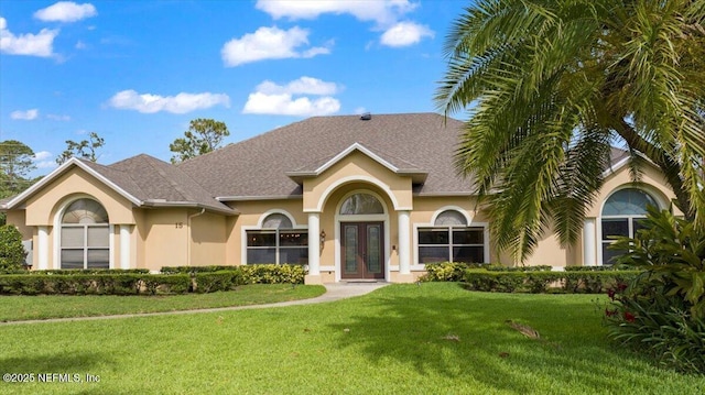 15 Dartmouth Trce, Ormond Beach, FL 32174 - view of front of property with a shingled roof, a front lawn, french doors, and stucco siding