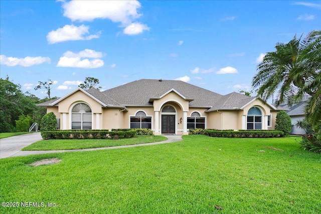 15 Dartmouth Trce, Ormond Beach, FL 32174 - ranch-style house featuring stucco siding, french doors, and a front lawn