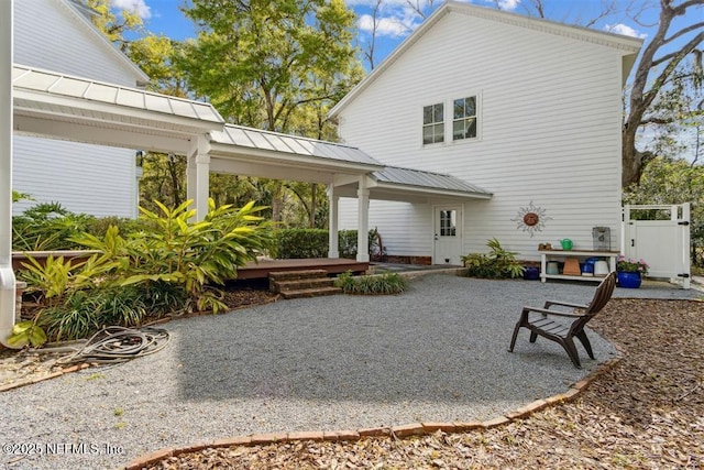 back of property featuring a patio area and metal roof