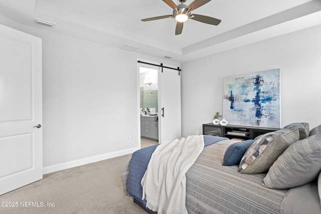 130 Juniper Hills Dr, Saint Johns, FL 32259 - bedroom with a barn door, light carpet, baseboards, ensuite bathroom, and a ceiling fan