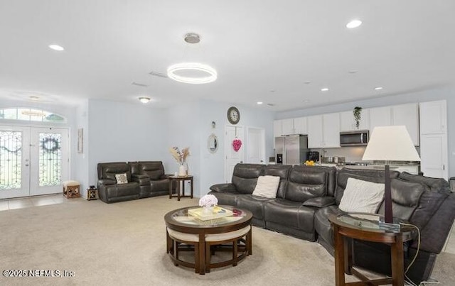 living room with light carpet, french doors, and recessed lighting