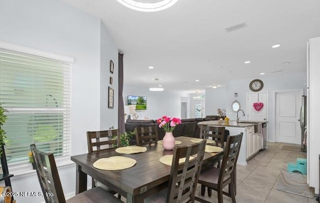dining room featuring light tile patterned floors and recessed lighting
