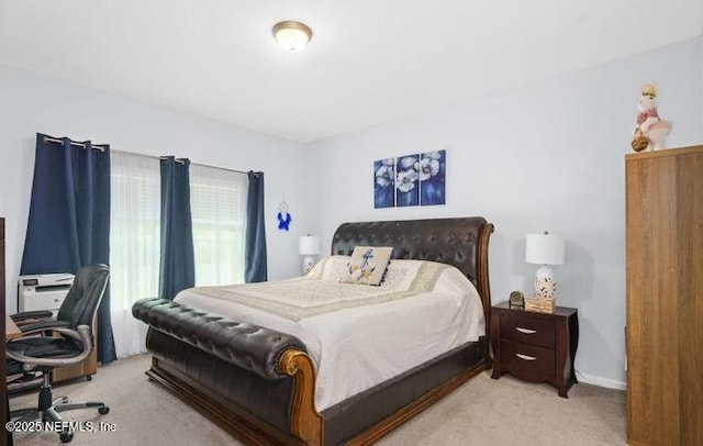bedroom featuring light carpet