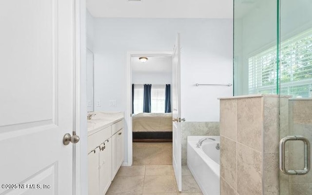 full bathroom with a garden tub, a stall shower, vanity, ensuite bath, and tile patterned floors