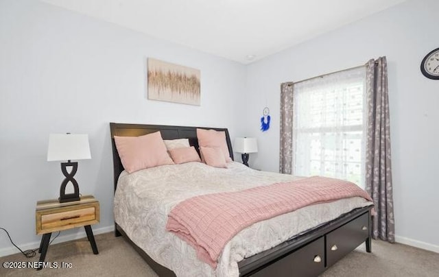 bedroom with light colored carpet and baseboards