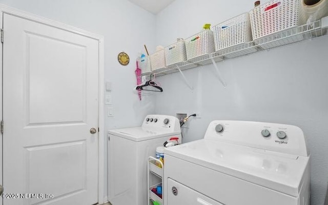laundry room with laundry area and washing machine and clothes dryer
