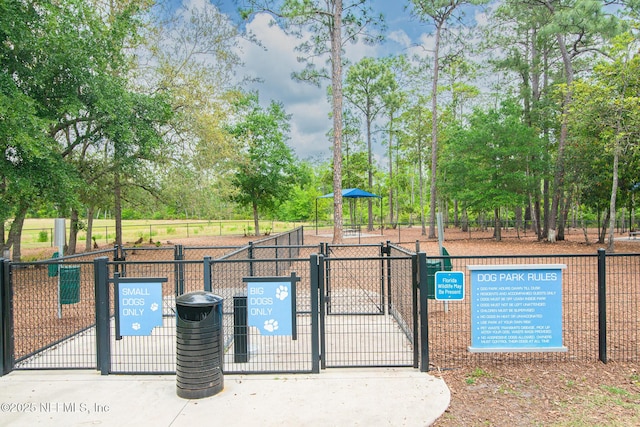 view of pool featuring a gate and fence