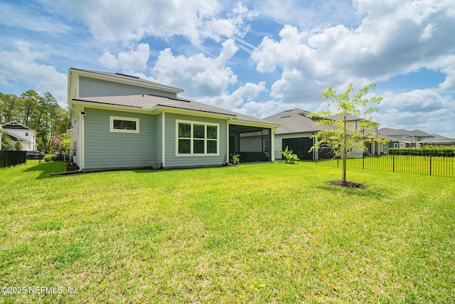 back of property featuring a sunroom, a fenced backyard, and a yard