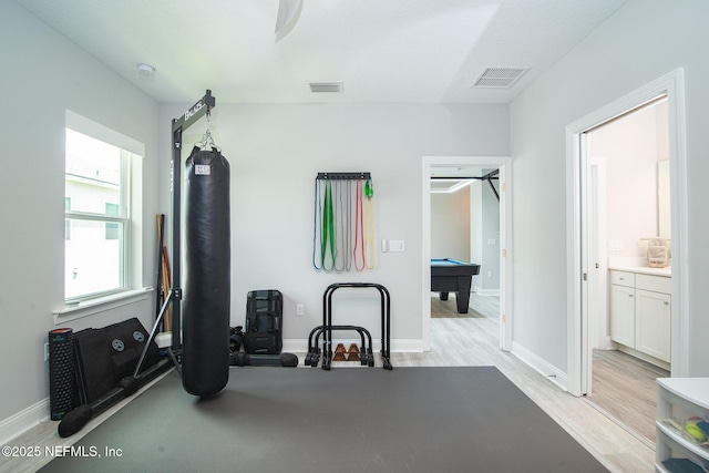 exercise room featuring pool table, visible vents, baseboards, and light wood-style floors