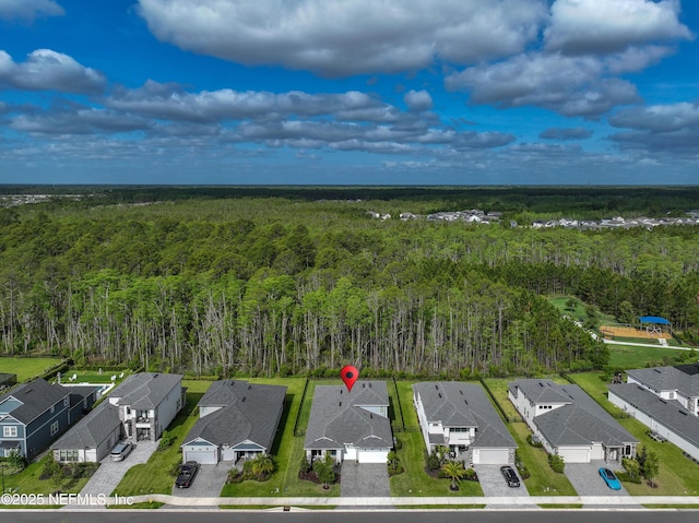 aerial view with a residential view and a wooded view