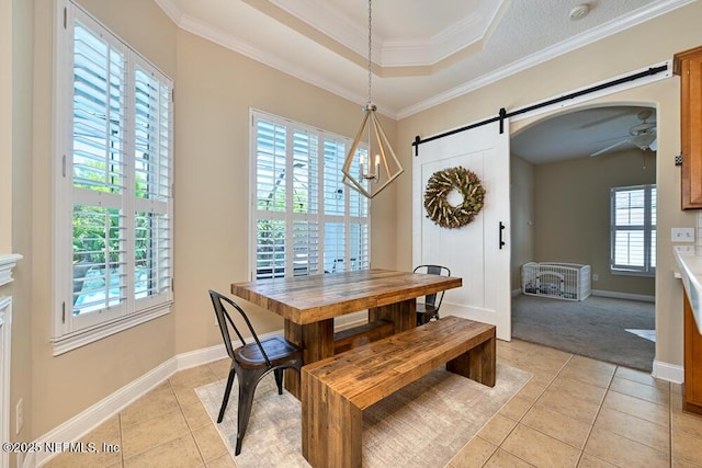 dining area featuring ceiling fan, baseboards, a barn door, and light tile patterned floors