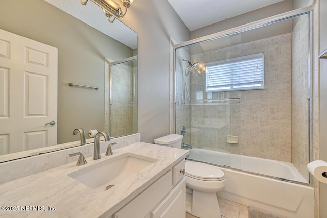 bathroom featuring bath / shower combo with glass door, toilet, and vanity