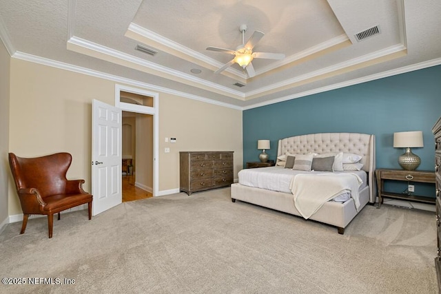 bedroom featuring carpet floors, visible vents, and a raised ceiling