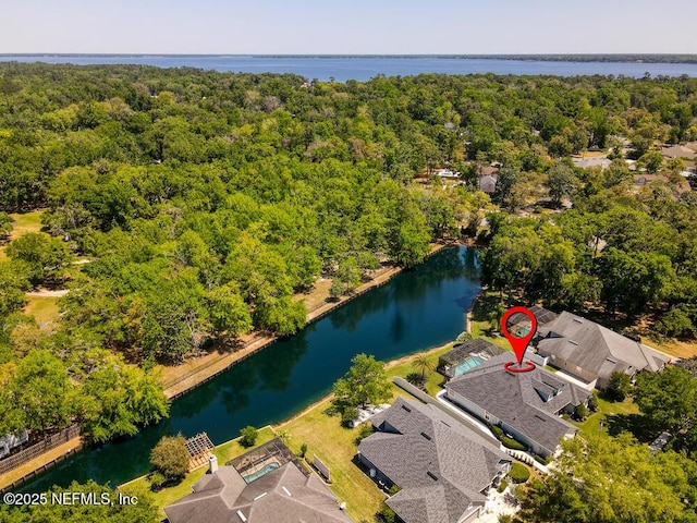aerial view with a forest view and a water view