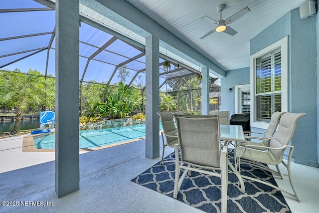 view of patio / terrace with an outdoor pool, a lanai, outdoor dining area, and ceiling fan