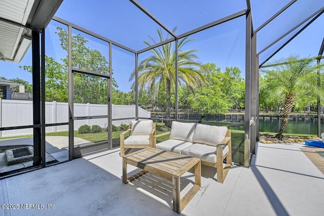 sunroom / solarium featuring a water view and an outdoor living space