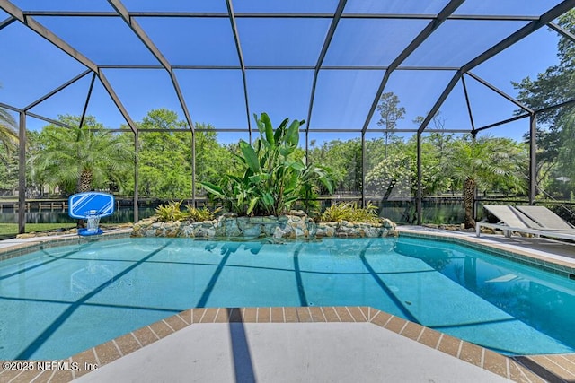 pool with a patio area and glass enclosure