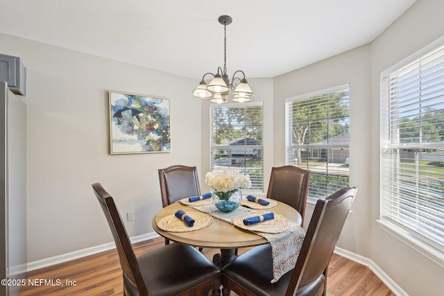 2734 Indigo Hills Ct, Jacksonville, FL 32221 - dining area featuring light wood-style flooring, baseboards, and a notable chandelier