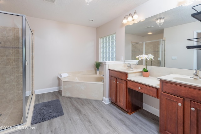 120 Oakwood Plantation Dr, Fleming Island, FL 32003 - full bathroom featuring a sink, double vanity, a stall shower, and wood finished floors