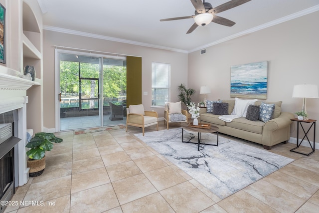 120 Oakwood Plantation Dr, Fleming Island, FL 32003 - living room featuring a ceiling fan, tile patterned floors, a tiled fireplace, and ornamental molding