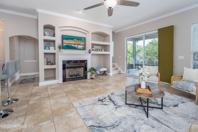 120 Oakwood Plantation Dr, Fleming Island, FL 32003 - living room featuring baseboards, a ceiling fan, built in features, and crown molding