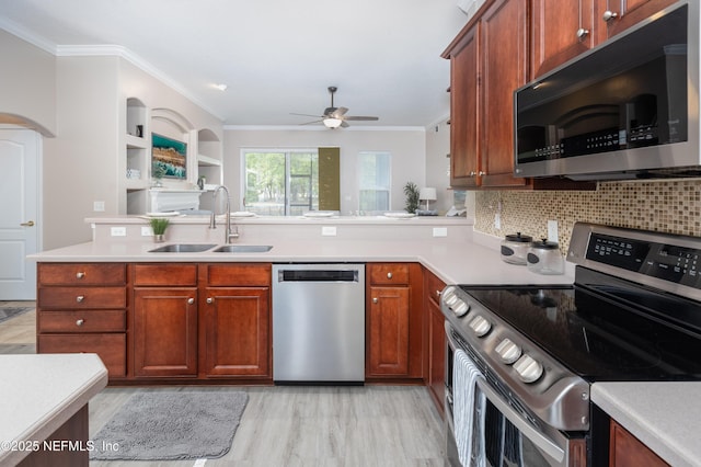 120 Oakwood Plantation Dr, Fleming Island, FL 32003 - kitchen featuring light countertops, a ceiling fan, crown molding, appliances with stainless steel finishes, and a sink
