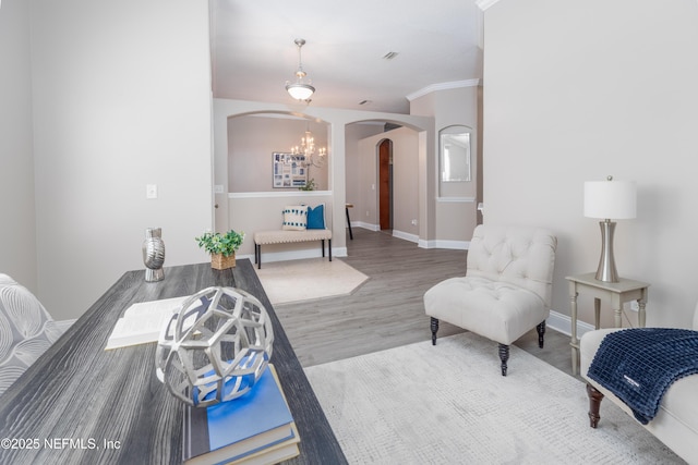 120 Oakwood Plantation Dr, Fleming Island, FL 32003 - interior space with baseboards, arched walkways, an inviting chandelier, crown molding, and wood finished floors