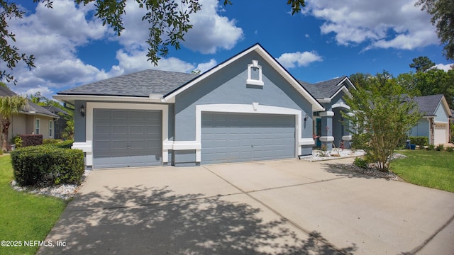 120 Oakwood Plantation Dr, Fleming Island, FL 32003 - single story home with driveway, stucco siding, an attached garage, and a front lawn