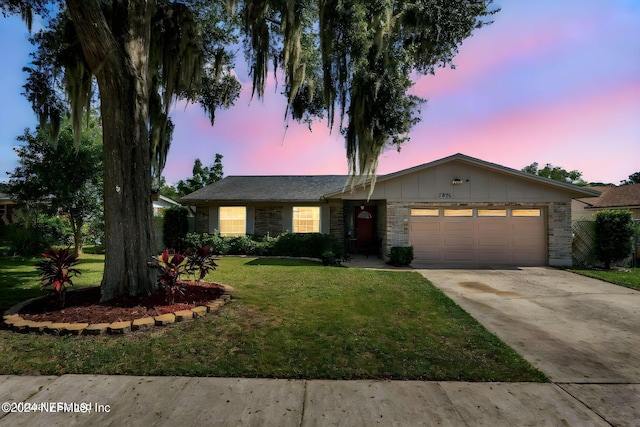 7876 Spanish Oaks Dr, Jacksonville, FL 32221 - single story home with an attached garage, a front lawn, driveway, stone siding, and board and batten siding