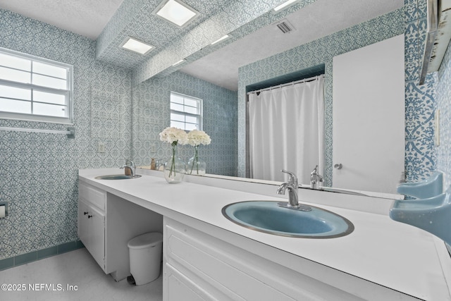 7876 Spanish Oaks Dr, Jacksonville, FL 32221 - bathroom with healthy amount of natural light, double vanity, and a textured ceiling
