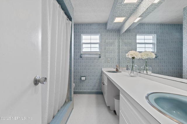 7876 Spanish Oaks Dr, Jacksonville, FL 32221 - bathroom with a textured ceiling, double vanity, tile patterned flooring, and baseboards