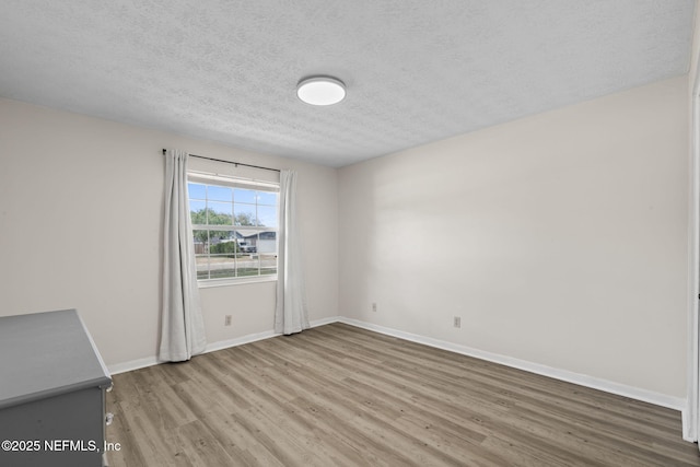 7876 Spanish Oaks Dr, Jacksonville, FL 32221 - empty room with wood finished floors, baseboards, and a textured ceiling