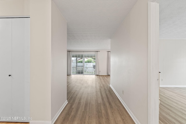 7876 Spanish Oaks Dr, Jacksonville, FL 32221 - corridor with wood finished floors, a textured ceiling, and baseboards