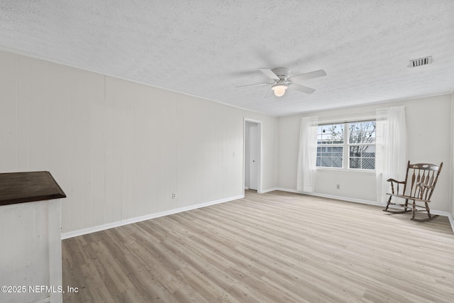 7876 Spanish Oaks Dr, Jacksonville, FL 32221 - spare room with a textured ceiling, wood finished floors, ceiling fan, and baseboards