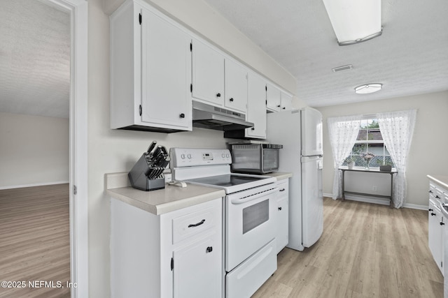 7876 Spanish Oaks Dr, Jacksonville, FL 32221 - kitchen with white appliances, under cabinet range hood, light countertops, light wood-type flooring, and white cabinets