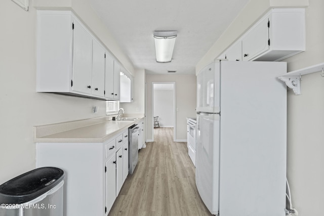 7876 Spanish Oaks Dr, Jacksonville, FL 32221 - kitchen with freestanding refrigerator, stainless steel dishwasher, a sink, light wood finished floors, and white cabinetry