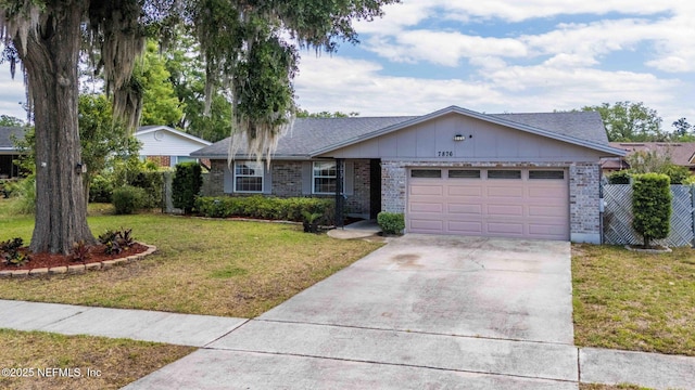 7876 Spanish Oaks Dr, Jacksonville, FL 32221 - ranch-style home with concrete driveway, an attached garage, brick siding, and a front yard