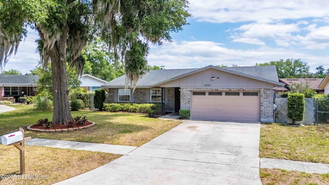 7876 Spanish Oaks Dr, Jacksonville, FL 32221 - ranch-style house with an attached garage, brick siding, driveway, and board and batten siding