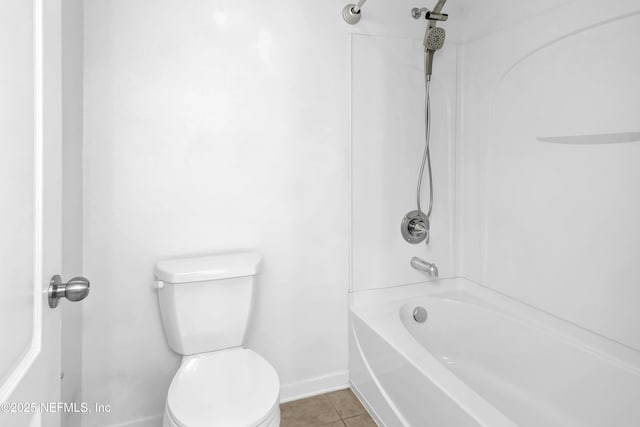 bathroom with toilet, bathtub / shower combination, baseboards, and tile patterned flooring