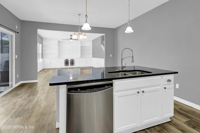 kitchen with white cabinets, a kitchen island with sink, dishwasher, a sink, and wood finished floors